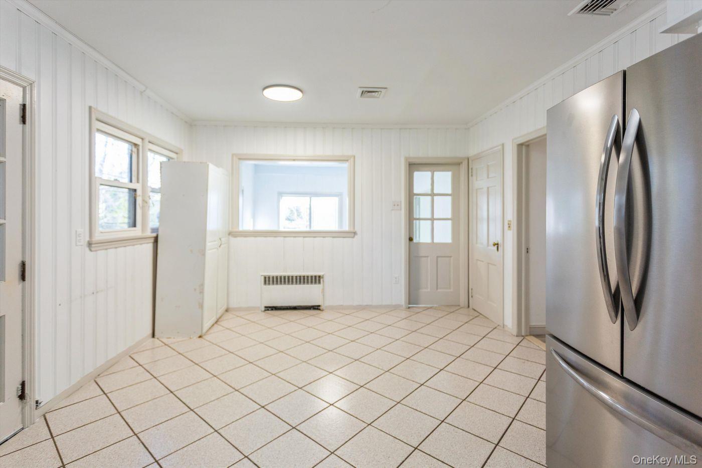 1 Sutton Place Lawrence, NY 11559 - Photo 5 of 38 a view of an empty room with window and cabinet