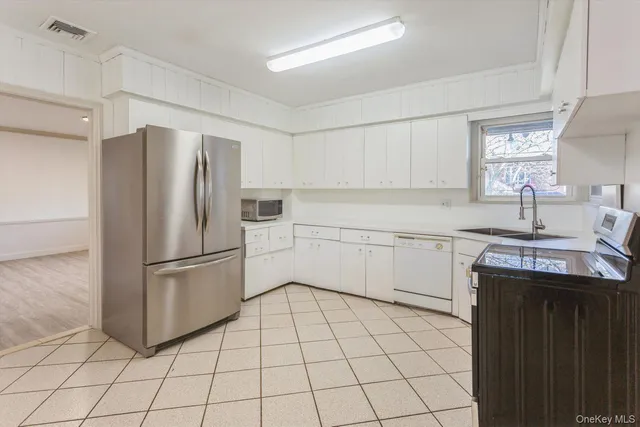 a kitchen with a refrigerator sink and stove