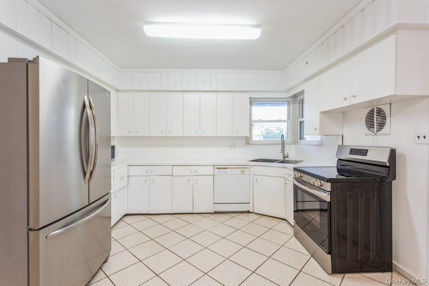 1 Sutton Place Lawrence, NY 11559 - Photo 7 of 38 a kitchen with a refrigerator sink and stove