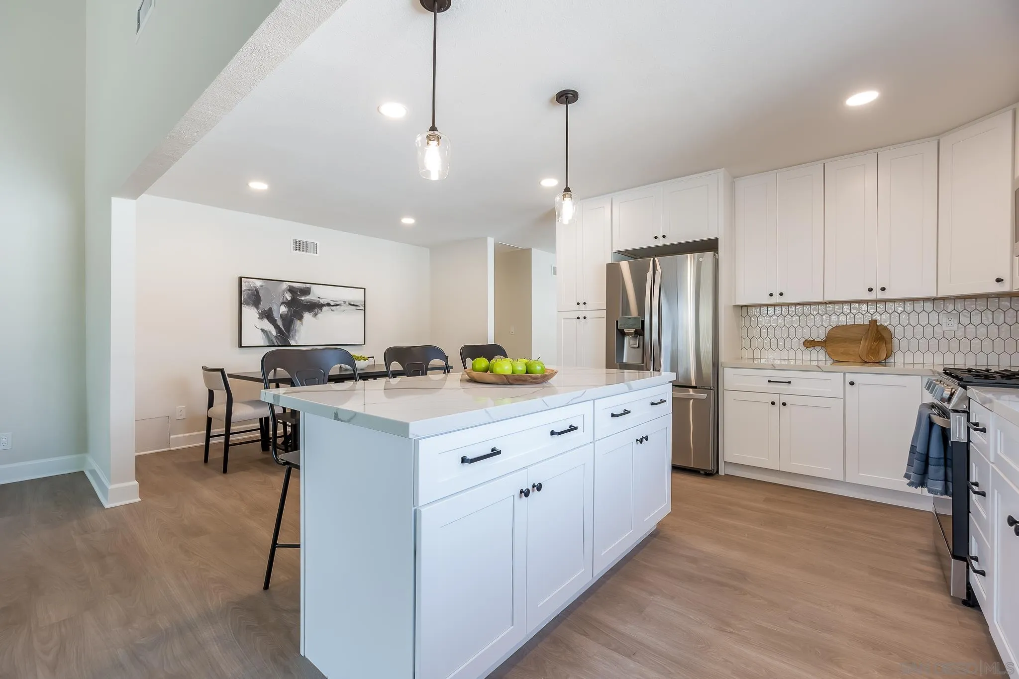 8510 Lepus Road San Diego, CA 92126 - Photo 14 of 35 a large kitchen with kitchen island a large counter top space a sink stainless steel appliances and cabinets