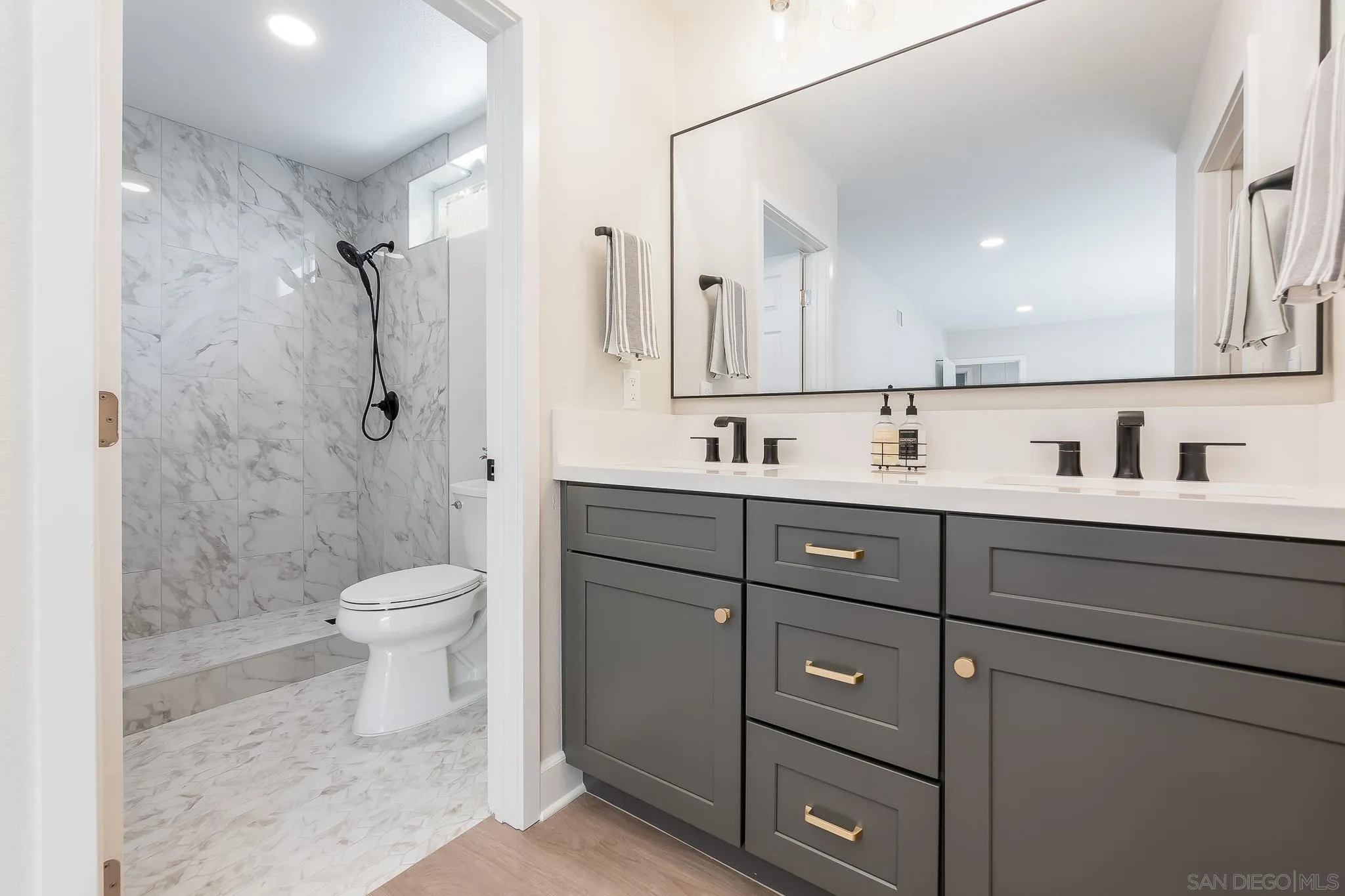 8510 Lepus Road San Diego, CA 92126 - Photo 4 of 35 a bathroom with a granite countertop sink a toilet and a mirror