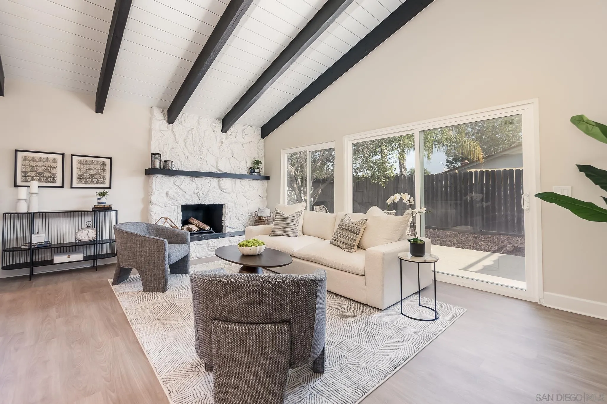 8510 Lepus Road San Diego, CA 92126 - Photo 5 of 35 a living room with furniture a large window and a fireplace