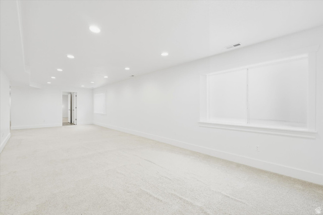 791 East Saddle Road Grantsville, UT 84029 - Photo 31 of 46 Spacious room featuring light-toned carpet flooring, recessed ceiling lighting, bright white walls, and a large window providing ample ambient light