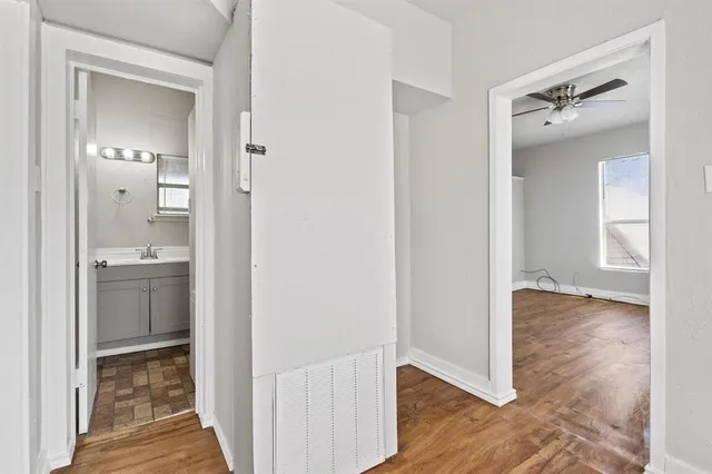 a view of a house with a big yard plants and large trees