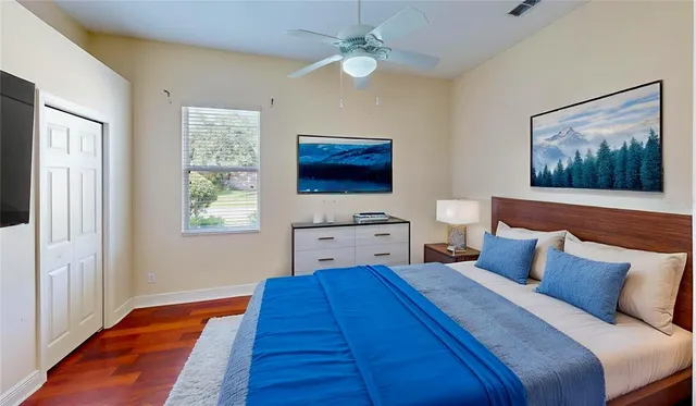 a bedroom with a bed and a painting on the wall