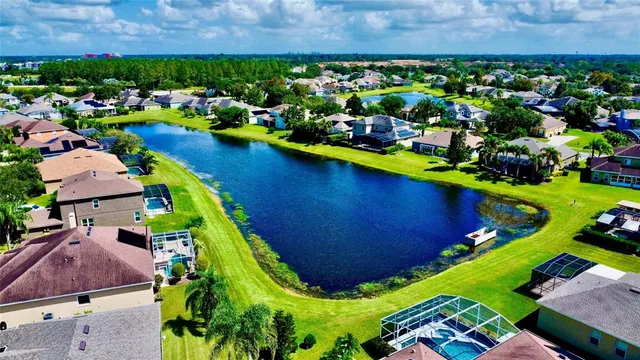 an aerial view of a house with a garden and swimming pool