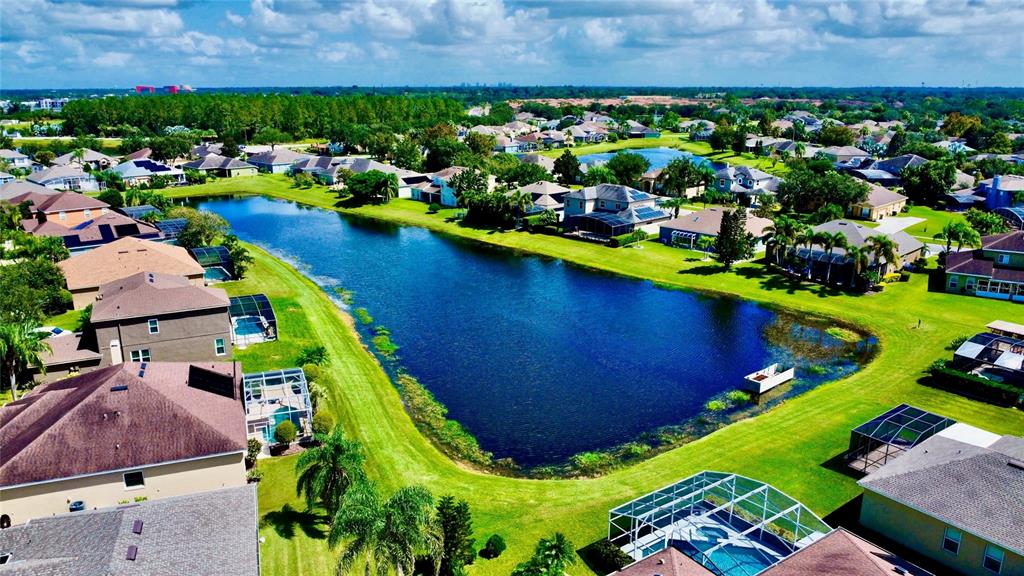 586 Huntington Pines Drive Ocoee, FL 34761 - Photo 18 of 51 an aerial view of a house with a garden and swimming pool