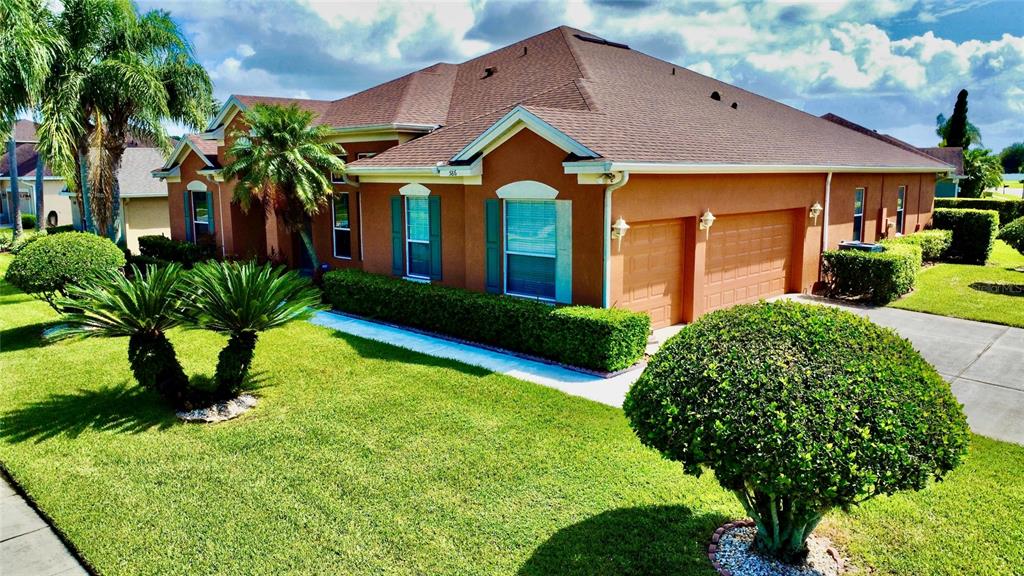 586 Huntington Pines Drive Ocoee, FL 34761 - Photo 2 of 51 a front view of a house with a yard