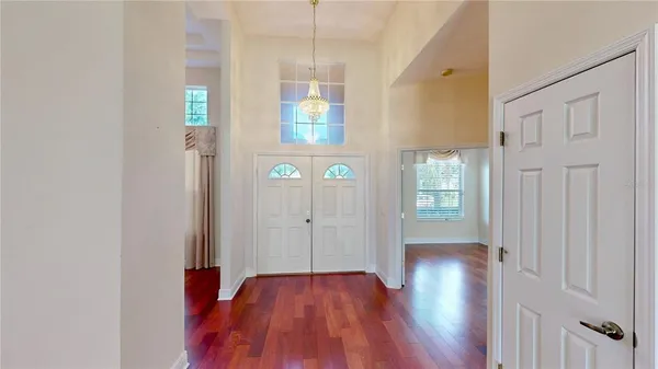 a view of hallway with wooden floor