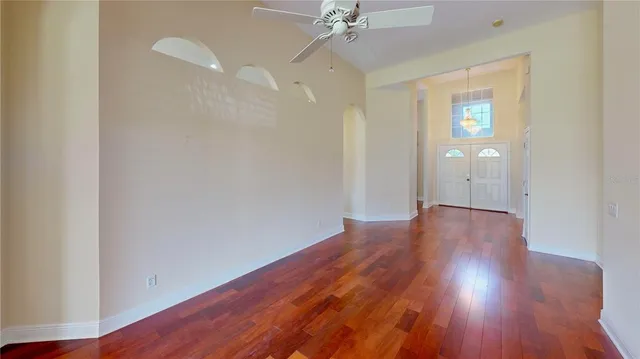 wooden floor in an empty room with a window