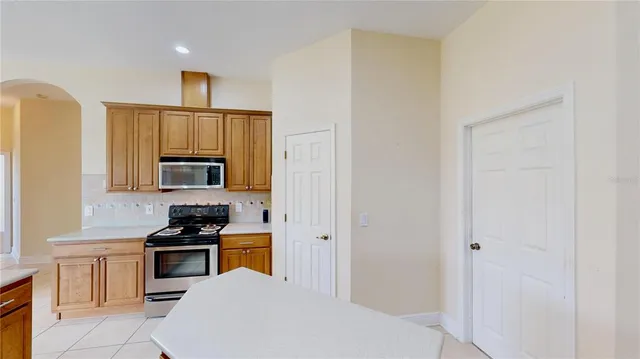 a kitchen with cabinets and appliances