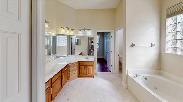 a large spacious bathroom with a large tub and shower