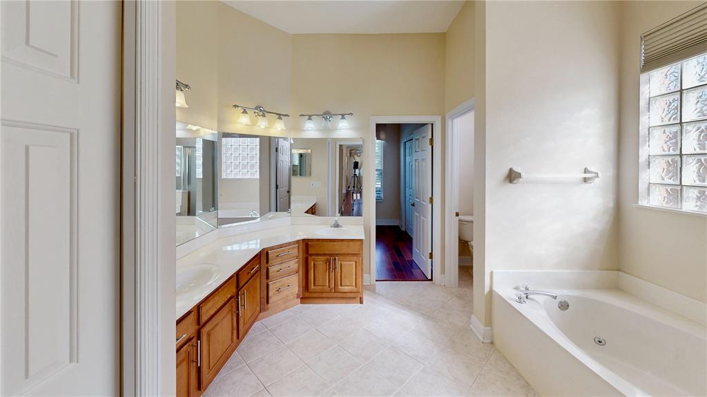 586 Huntington Pines Drive Ocoee, FL 34761 - Photo 38 of 51 a large spacious bathroom with a large tub and shower