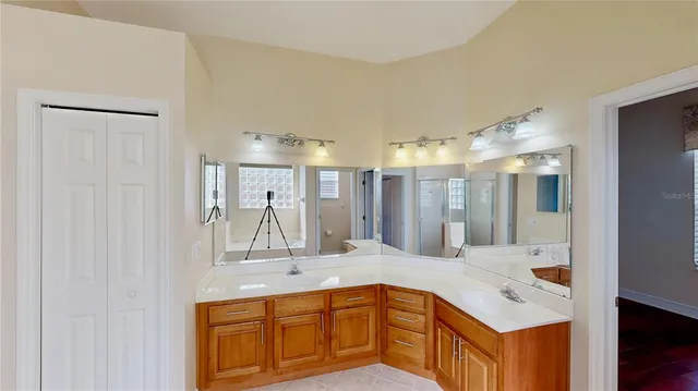 a bathroom with a double vanity sink and mirror