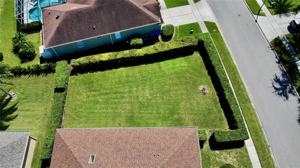 an aerial view of a house with a yard and outdoor seating