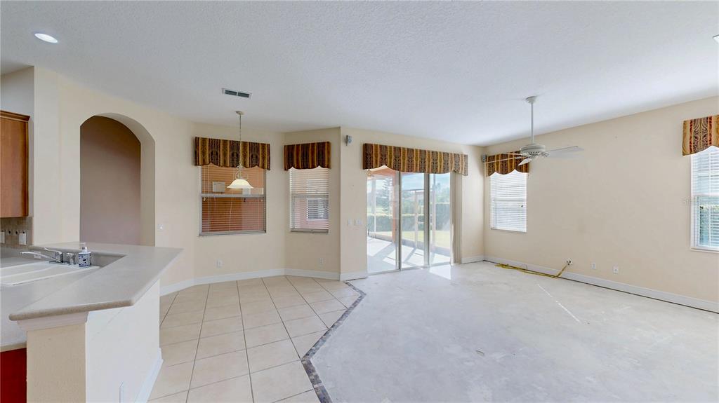 586 Huntington Pines Drive Ocoee, FL 34761 - Photo 7 of 51 a view of an empty room with a window
