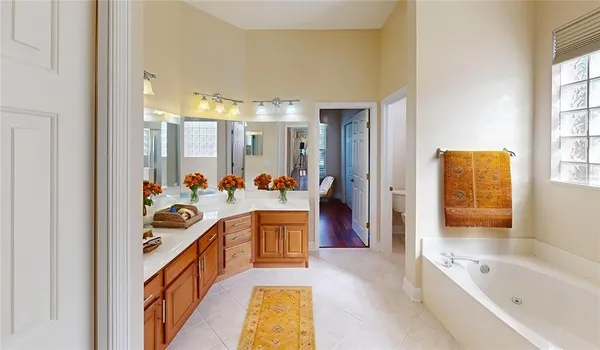 a bathroom with a tub sink and mirror