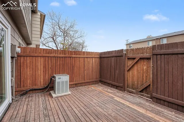 a view of a roof deck with wooden floor and fence