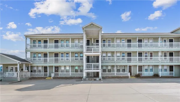 a front view of a building with a lot of windows