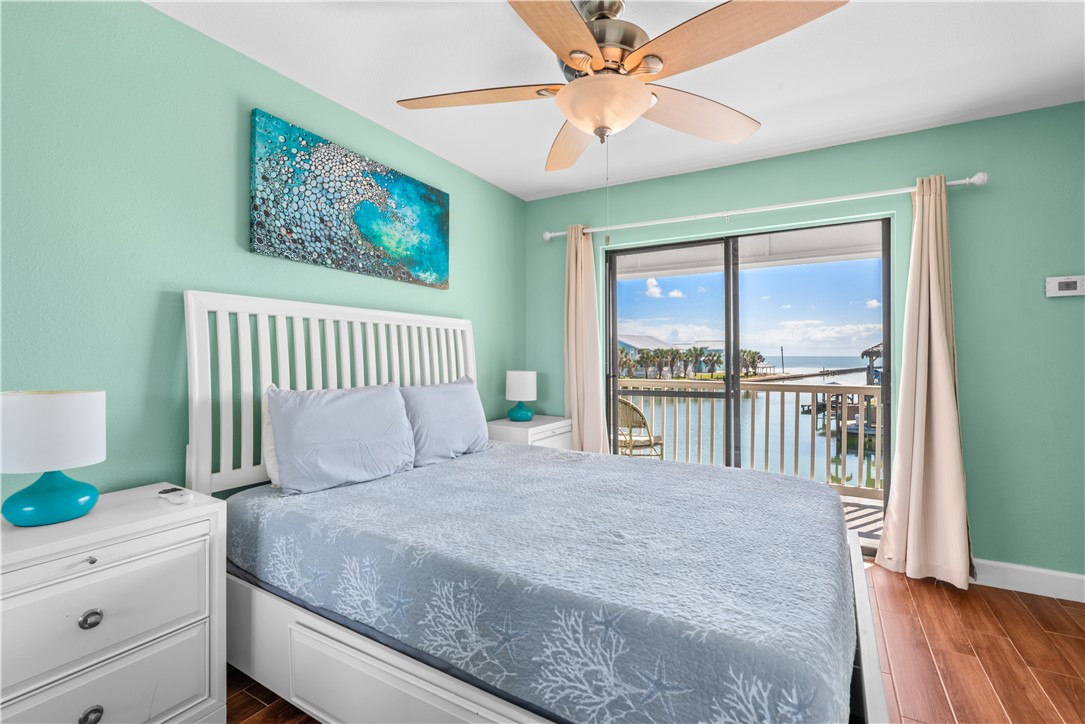 2290 North Fulton Beach Road, Unit 212 Rockport, TX 78382 - Photo 12 of 19 a bedroom with a large bed and a window