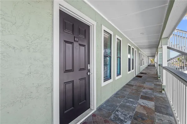 a view of a porch with wooden floor and stairs