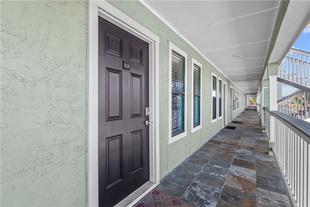 2290 North Fulton Beach Road, Unit 212 Rockport, TX 78382 - Photo 3 of 19 a view of a porch with wooden floor and stairs