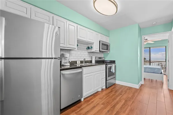 a kitchen with stainless steel appliances granite countertop a refrigerator sink and cabinets