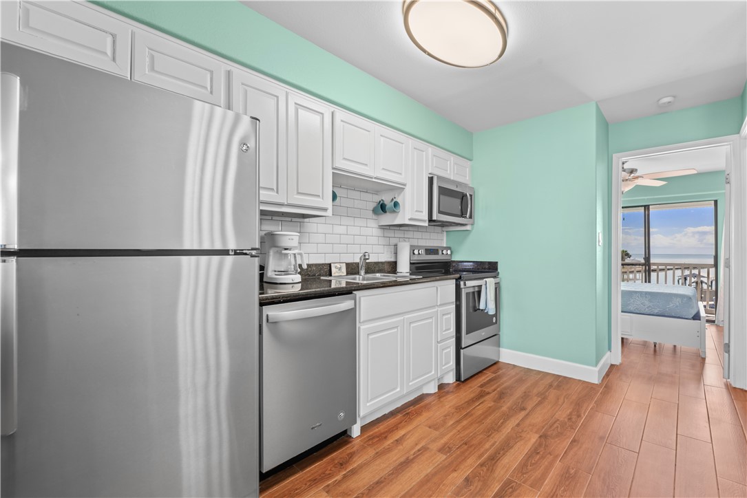 2290 North Fulton Beach Road, Unit 212 Rockport, TX 78382 - Photo 7 of 19 a kitchen with stainless steel appliances granite countertop a refrigerator sink and cabinets