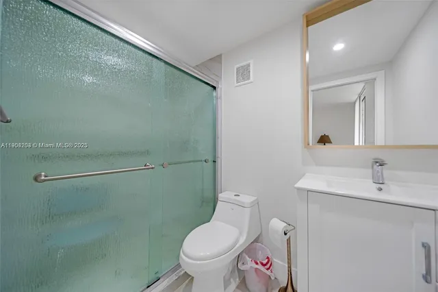 a bathroom with a toilet sink and shower