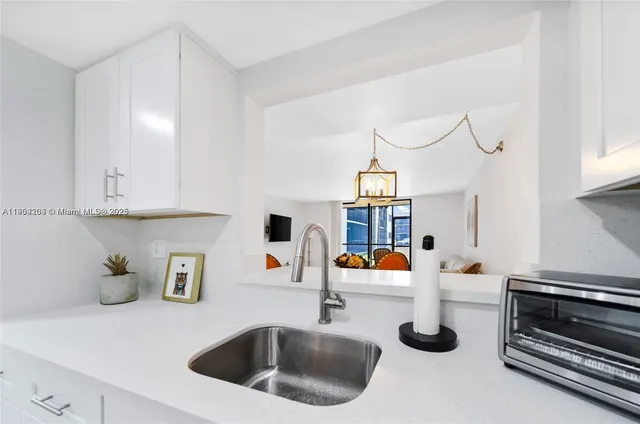 a kitchen with a sink and a stove top oven