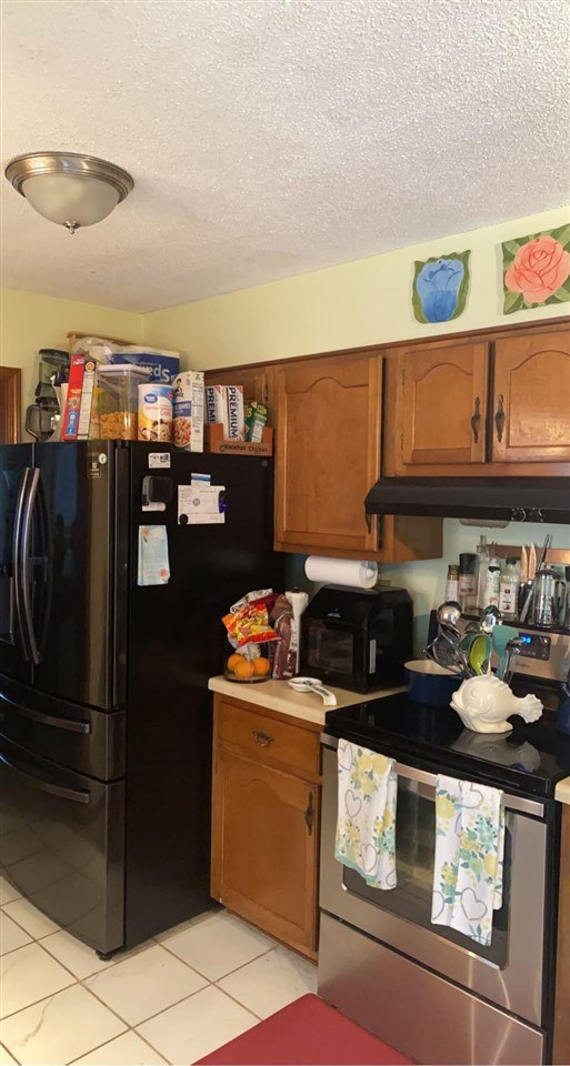 3894 Ross Road Memphis, TN 38115 - Photo 3 of 11 a kitchen with stainless steel appliances granite countertop a stove and a refrigerator