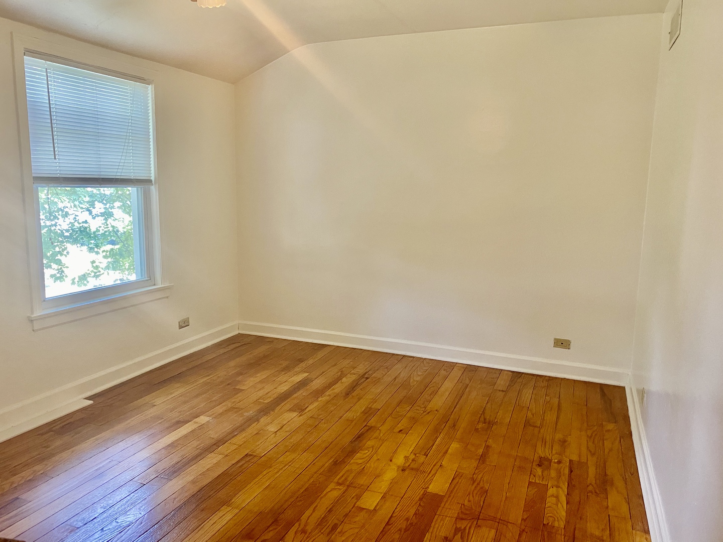 163 East Burlington Street Riverside, IL 60546 - Photo 5 of 7 a view of an empty room with wooden floor and a window