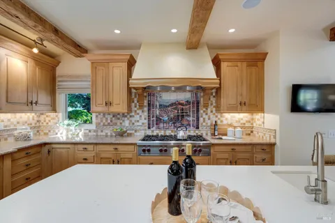 a kitchen with stainless steel appliances granite countertop a sink and a refrigerator