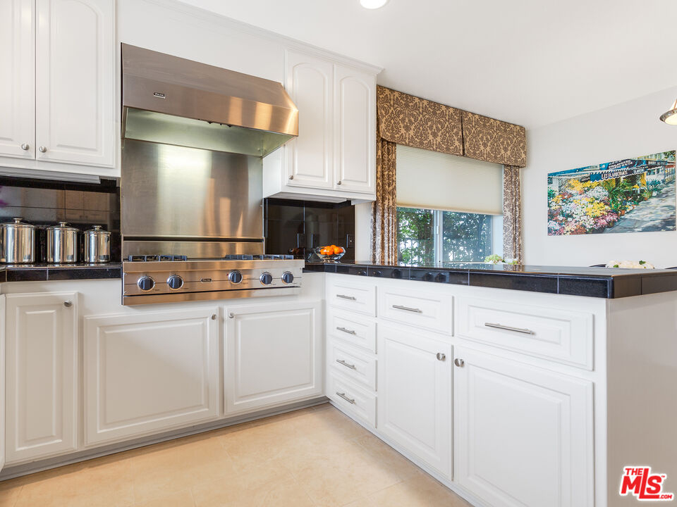 4324 Hillview Drive Malibu, CA 90265 - Photo 14 of 24 a kitchen with stainless steel appliances granite countertop a refrigerator and cabinets