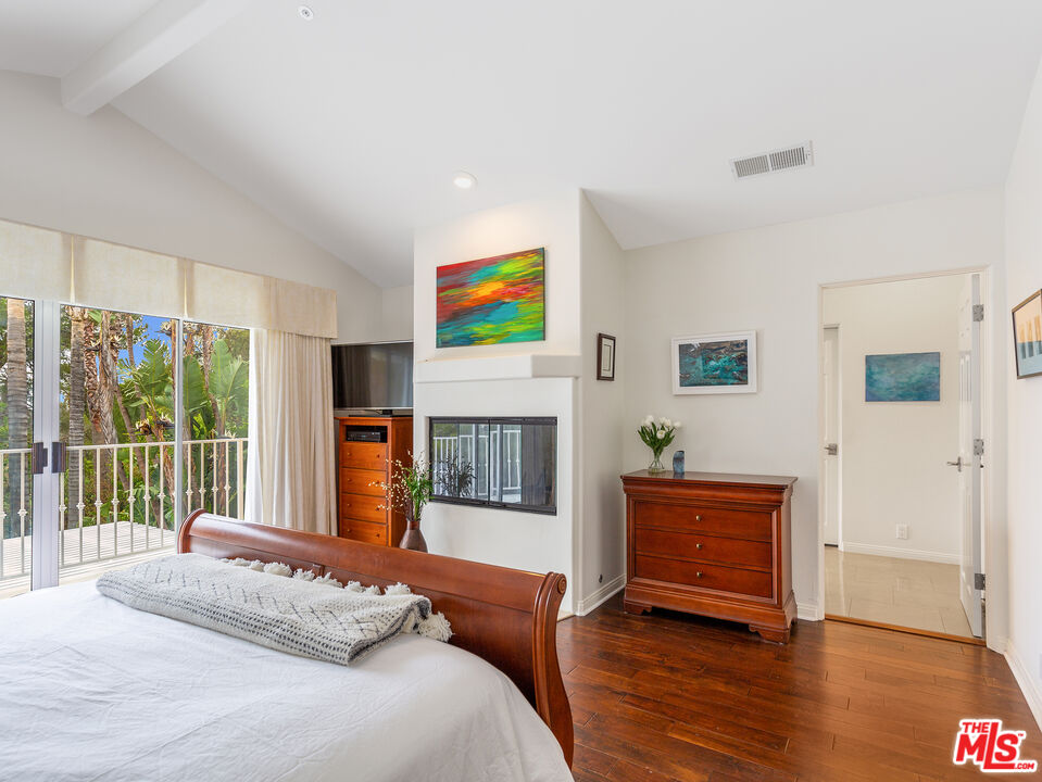 4324 Hillview Drive Malibu, CA 90265 - Photo 17 of 24 a bedroom with a bed and a fireplace