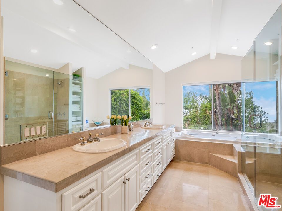 4324 Hillview Drive Malibu, CA 90265 - Photo 19 of 24 a bathroom with a granite countertop sink and a large window