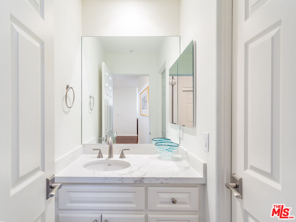 4324 Hillview Drive Malibu, CA 90265 - Photo 21 of 24 a bathroom with a sink and a mirror