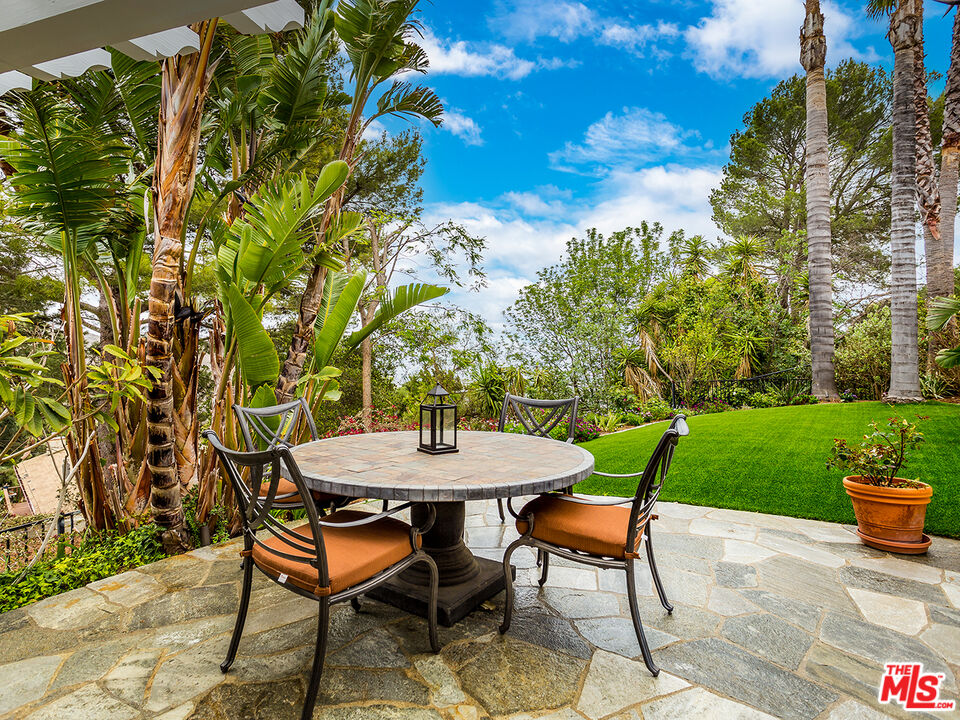 4324 Hillview Drive Malibu, CA 90265 - Photo 22 of 24 a backyard of a house with table and chairs