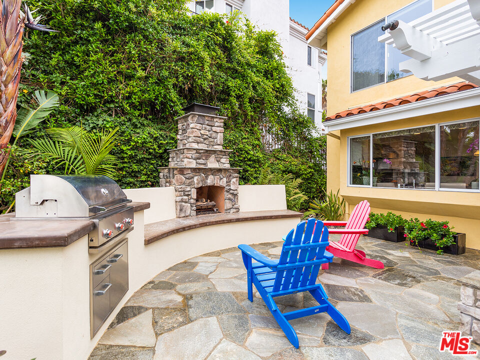 4324 Hillview Drive Malibu, CA 90265 - Photo 24 of 24 a roof deck with table and chairs and potted plants