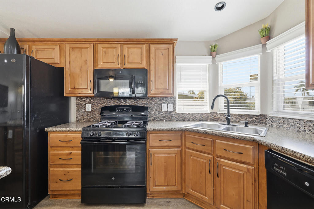 1657 Lime Avenue, Unit 87 Oxnard, CA 93033 - Photo 11 of 37 a kitchen with stainless steel appliances granite countertop a stove a sink and a microwave