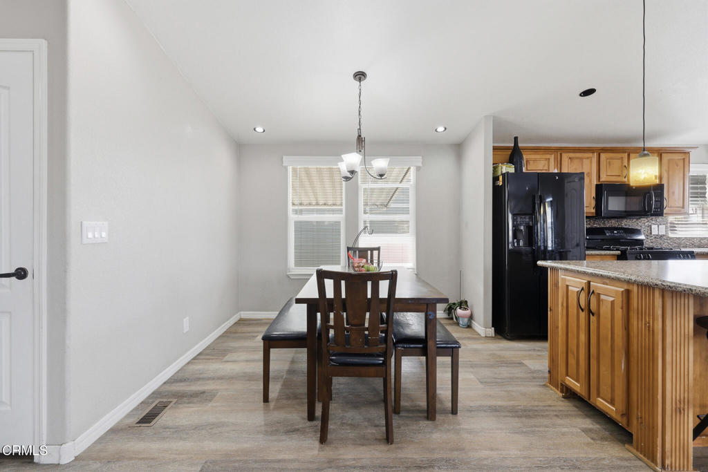 1657 Lime Avenue, Unit 87 Oxnard, CA 93033 - Photo 14 of 37 a view of a dining room with furniture window and wooden floor