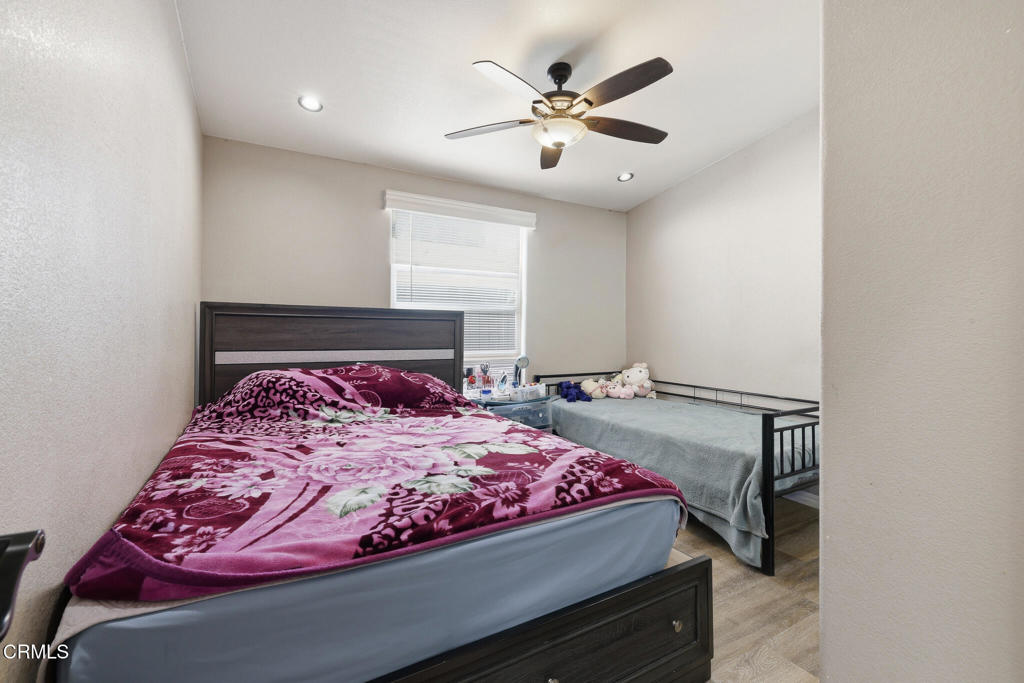 1657 Lime Avenue, Unit 87 Oxnard, CA 93033 - Photo 16 of 37 a bedroom with a bed and a chandelier