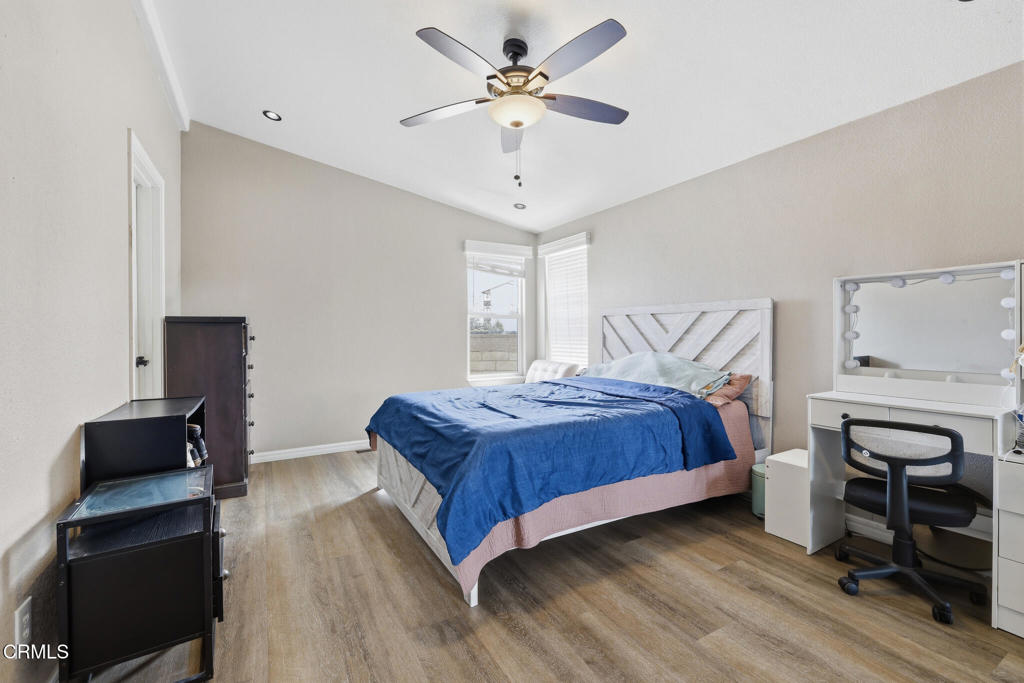1657 Lime Avenue, Unit 87 Oxnard, CA 93033 - Photo 18 of 37 a bedroom with a bed and a chandelier