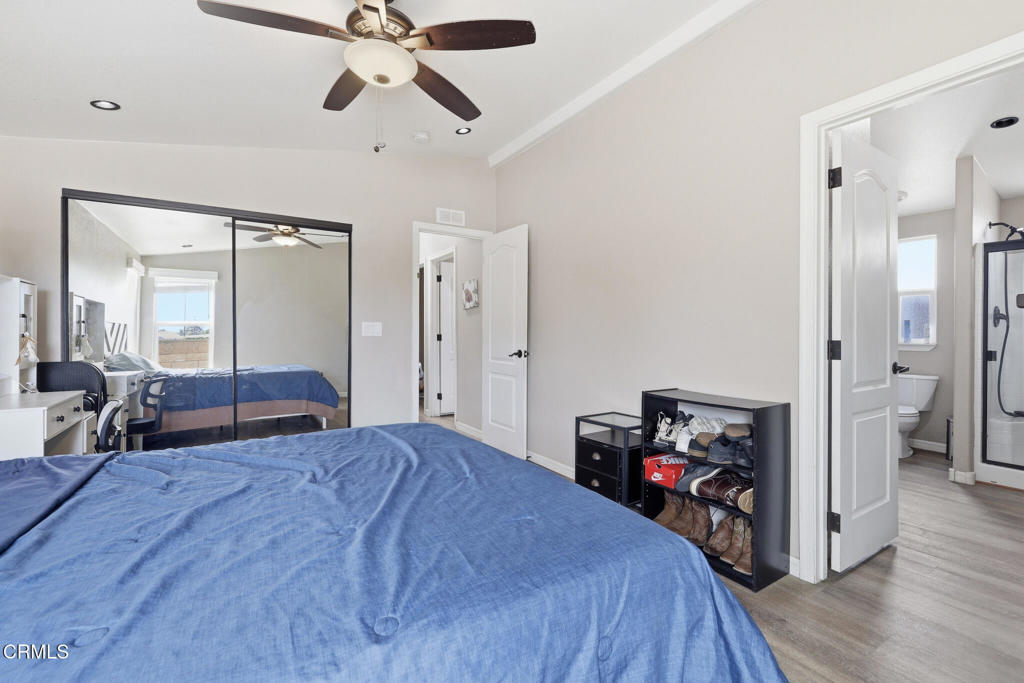 1657 Lime Avenue, Unit 87 Oxnard, CA 93033 - Photo 19 of 37 a bedroom with a bed and a chandelier