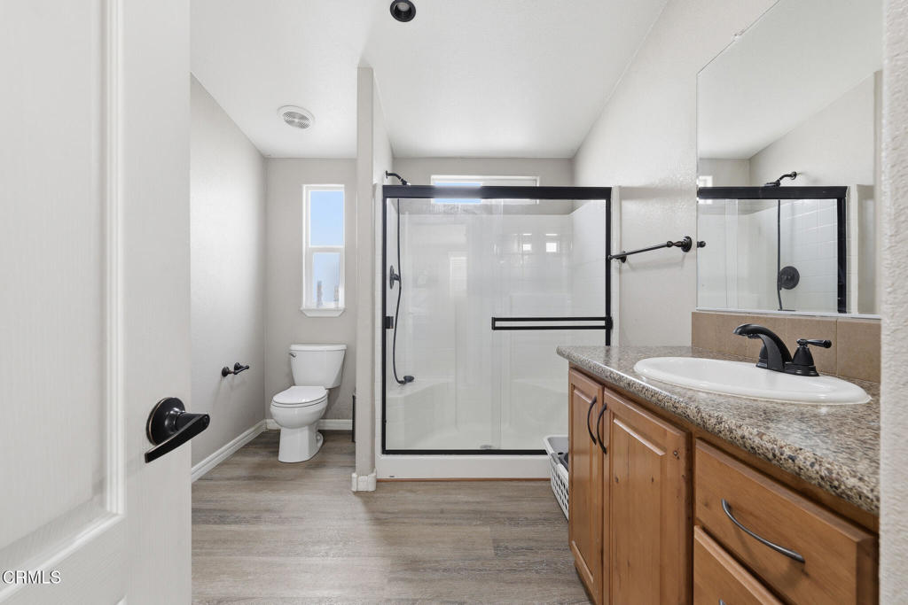 1657 Lime Avenue, Unit 87 Oxnard, CA 93033 - Photo 20 of 37 a bathroom with a granite countertop sink toilet and shower