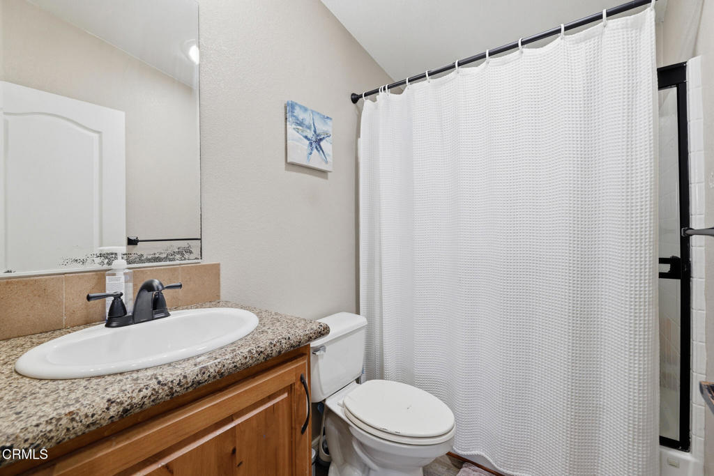 1657 Lime Avenue, Unit 87 Oxnard, CA 93033 - Photo 23 of 37 a bathroom with a granite countertop sink and a mirror