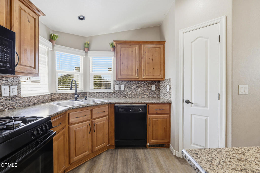 1657 Lime Avenue, Unit 87 Oxnard, CA 93033 - Photo 9 of 37 a kitchen with a sink stove and cabinets