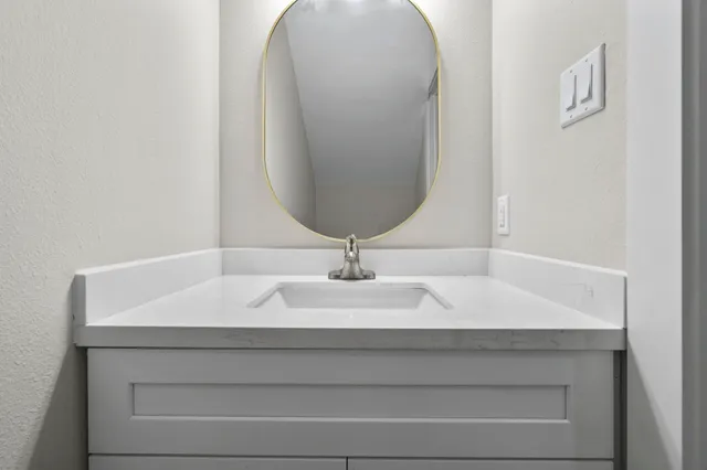 a view of a kitchen with a sink dishwasher a kitchen island with wooden floor and cabinets