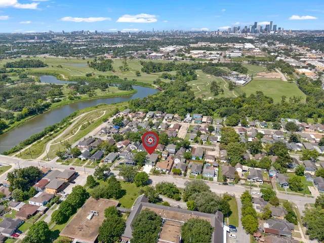 an aerial view of residential houses with city view