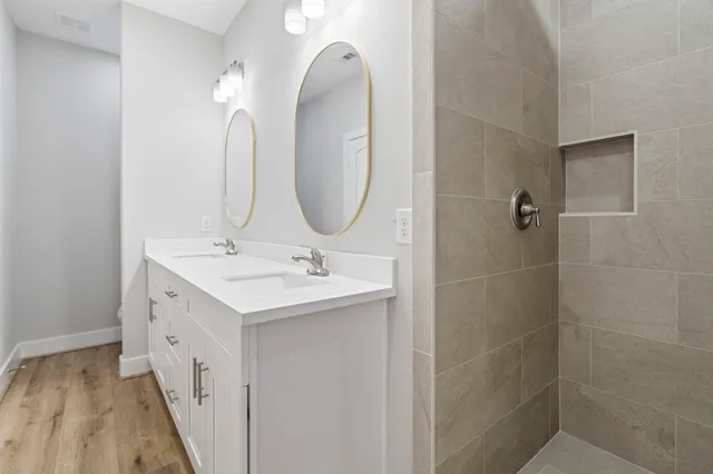 a bathroom with a double vanity sink and a mirror